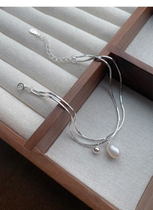 Detail of S925 sterling silver double-layer bracelet with freshwater pearl and silver beads