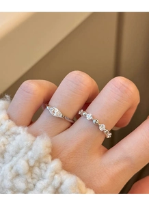 Detail of S925 silver marquise-cut and pave band rings layered on model fingers