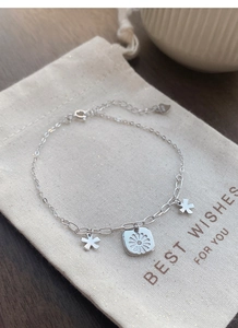 Detailed view of S925 sterling silver daisy bracelet with star charms and adjustable clasp