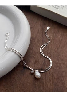 Macro detail of S925 sterling silver stamp on double layer snake chain with freshwater pearl