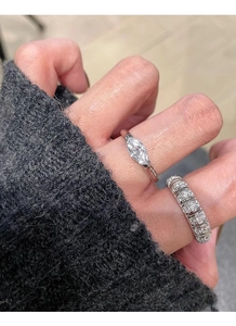 Close-up of S925 silver angel eye ring with marquise cut diamond and pavé band