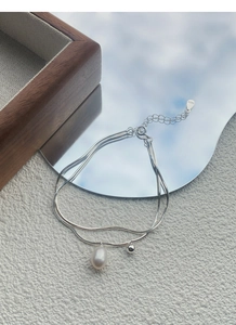 Detail of S925 sterling silver double-layer bracelet with freshwater pearl and silver tag