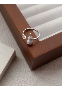 Macro shot of S925 sterling silver ring featuring a matte finish gourd charm and S925 stamp