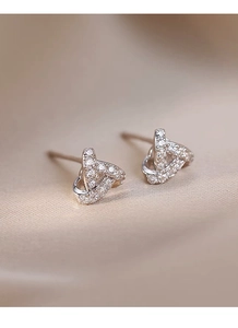 Detailed macro view of S999 sterling silver triangle earrings with sparkling zircons