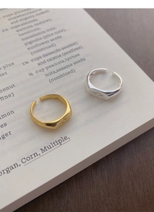Macro detail of silver and gold north star rings on a book with polished finish