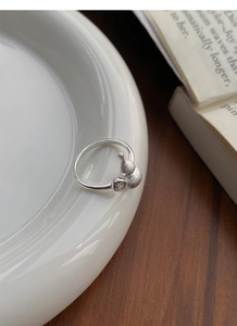 Detail of a matte finished S925 silver gourd ring with a small zircon accent