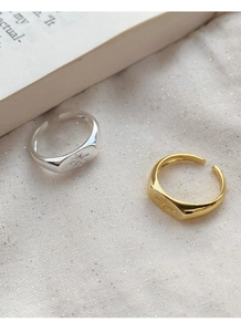 Detail of gold and silver S925 sterling silver rings with starburst engraving