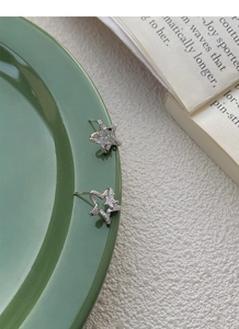 Macro shot of S925 sterling silver star stud earrings featuring sparkling cubic zirconia