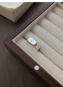 Macro shot of S925 silver signet ring with an eight-pointed star in a jewelry box