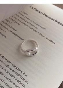 Macro detail of S925 sterling silver stamp on minimalist adjustable hollow oval ring