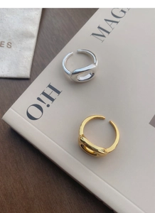 Macro detail showing S925 hallmark on minimalist hollow oval open rings in silver and gold