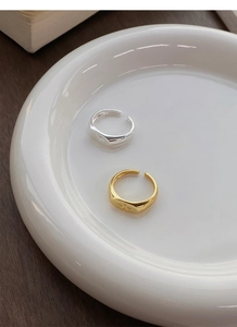 Detail of adjustable S925 sterling silver star rings in gold and silver finish on tray