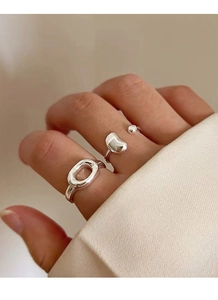 Detail of S925 sterling silver bean open ring and oval chain ring worn on finger