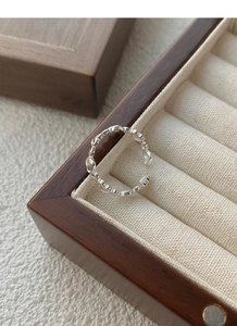 Detail of S925 sterling silver open heart ring displayed on a premium walnut jewelry box