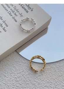 Close-up of adjustable S925 sterling silver heart rings in gold and silver finishes