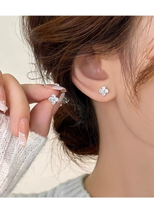 Macro shot of S999 silver four-leaf clover stud earrings set with sparkling zircons