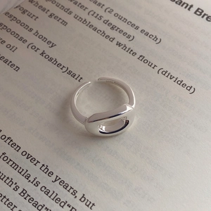 Minimalist S925 sterling silver open oval hollow ring on a vintage book page