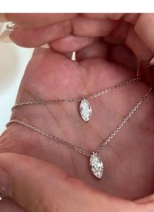Detailed view of two marquise-cut marquise stone necklaces on delicate silver chains