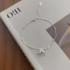 Bracciale minimalista in argento sterling S925 con fiocco su sfondo artistico e accogliente