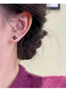 Close-up of elegant black clover zircon earrings in S999 sterling silver for women