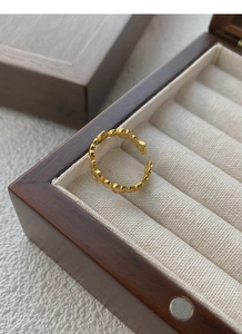 Macro shot of gold adjustable heart-shaped ring in a luxury velvet jewelry box