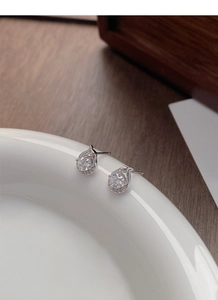 Macro detail of S925 sterling silver teardrop studs with sparkling zircon stones