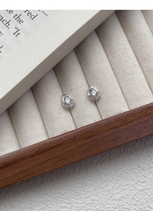 Detailed macro shot of S999 silver snake earrings with water-drop cubic zirconia stones