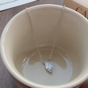 Elegant S925 sterling silver marquise cut zircon necklace displayed in a ceramic cup