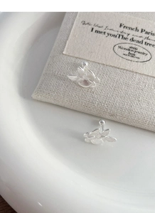Macro shot of butterfly silver studs with brushed texture and screw back closures