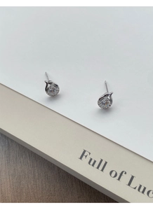 Macro detail of S999 sterling silver snake earrings with round zircon and crystal accents