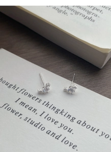 Macro detail of S999 sterling silver stud earrings with sparkling cubic zirconia stones
