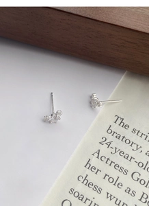 Detailed 45-degree angle of sparkling zircon stud earrings in S999 sterling silver