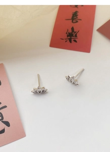 Macro view of S999 sterling silver lotus stud earrings with fine polished details