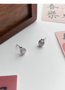 Detailed close-up of S999 sterling silver snake earrings with sparkling zircon gemstones
