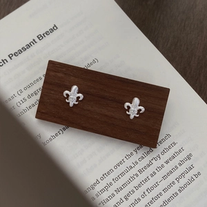 Brushed S925 sterling silver fleur-de-lis stud earrings with small diamond accent