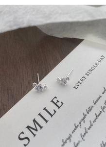 Close-up of S999 sterling silver stud earrings with sparkling round cubic zirconia