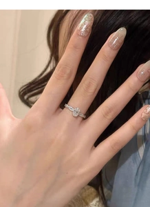Close-up of S925 silver ring featuring an oval zircon and a crisscross diamond band