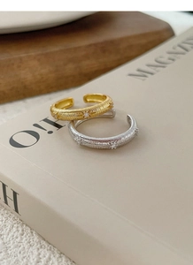 Detailed macro of vintage silver and gold star rings with textured brushed metal finish