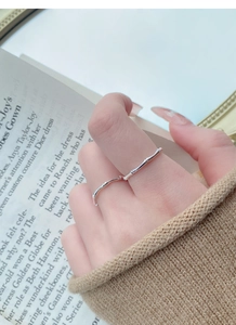 Macro view of slender S999 silver ring with bamboo joint texture on a model finger