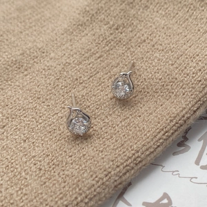 Minimalist S999 sterling silver snake earrings with sparkling cubic zirconia on knit fabric