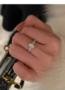 Detail of an S925 silver oval-cut zircon ring with twisted pavé band on model's hand