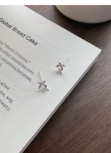 Macro detail of S999 sterling silver osmanthus flower stud earrings with zircon inlay