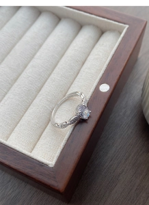 Close-up of S925 sterling silver ring with oval zircon and intricate interlaced bands
