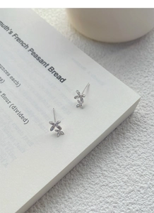 Detail of S999 silver osmanthus flower stud earrings with sparkling cubic zirconia stones