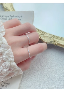 Detailed close-up of two S999 sterling silver bamboo joint rings on model fingers