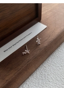 Macro detail of S925 silver sweet osmanthus flower stud earrings with sparkling zircons
