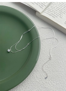 Detailed macro shot of S925 sterling silver necklace featuring a solitaire zirconia stone