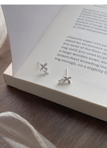 Detailed macro view of S925 sterling silver butterfly earrings with sparkling cubic zirconia