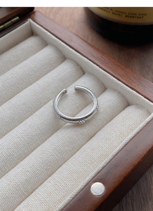 Detail of S925 sterling silver star ring with vertical brushed texture in a jewelry box