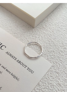 Detail shot of a silver bamboo joint ring with high-gloss finish on white velvet